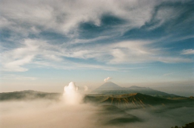 A volcanic landscape beneath a dramatic sky