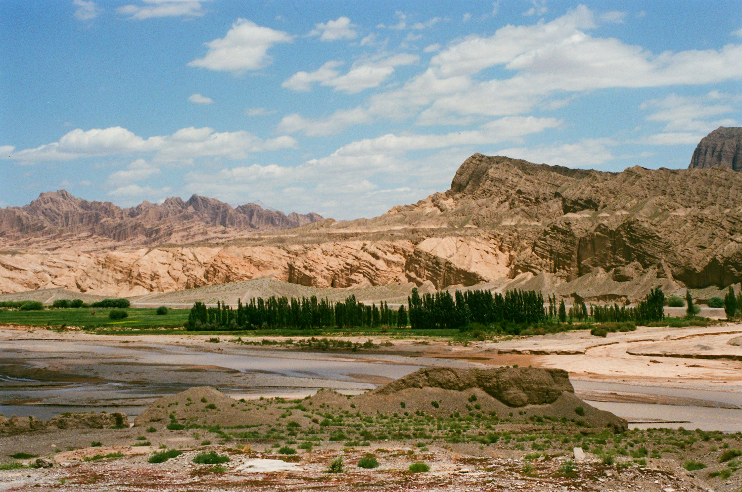 A broad rocky landscape beneath a blue sky