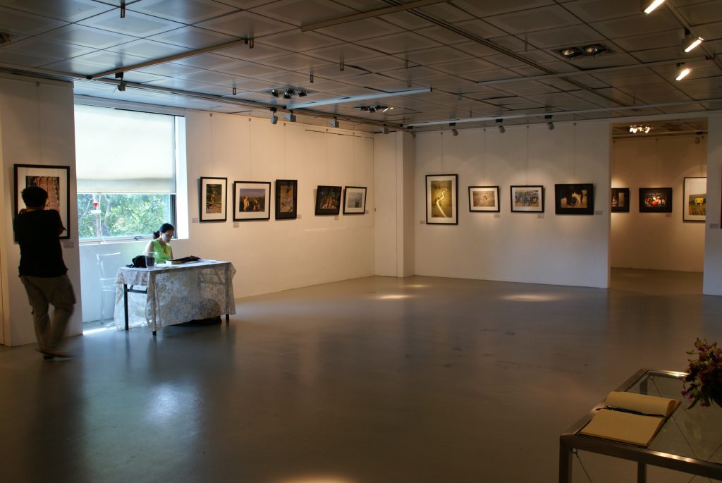 A wide view of framed photographs displayed in a gallery