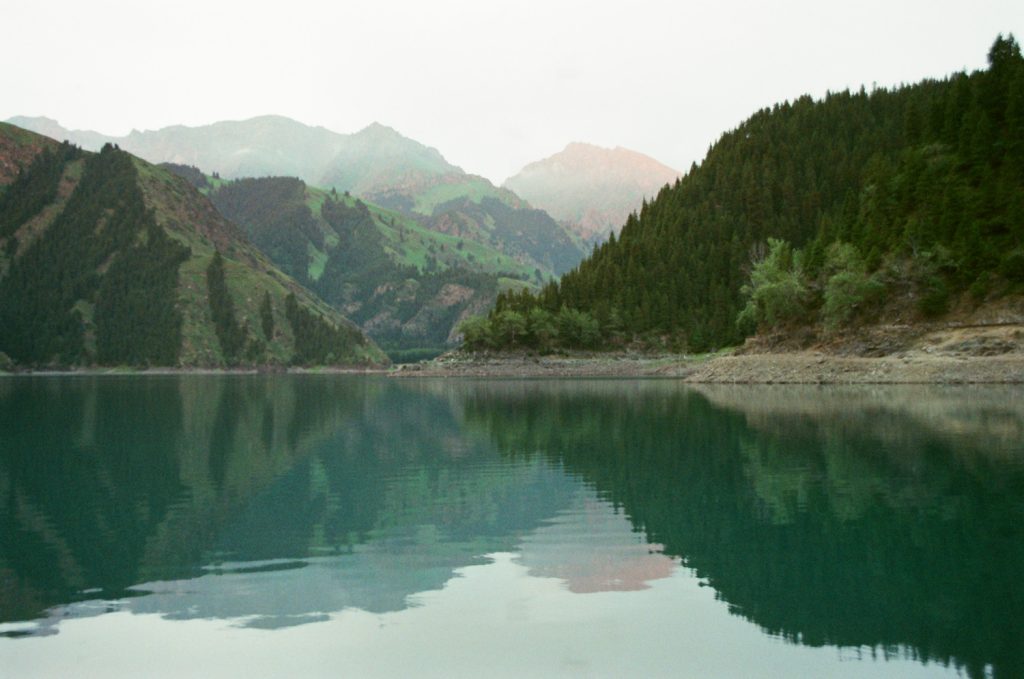 A mountain lake reflecting a forested valley