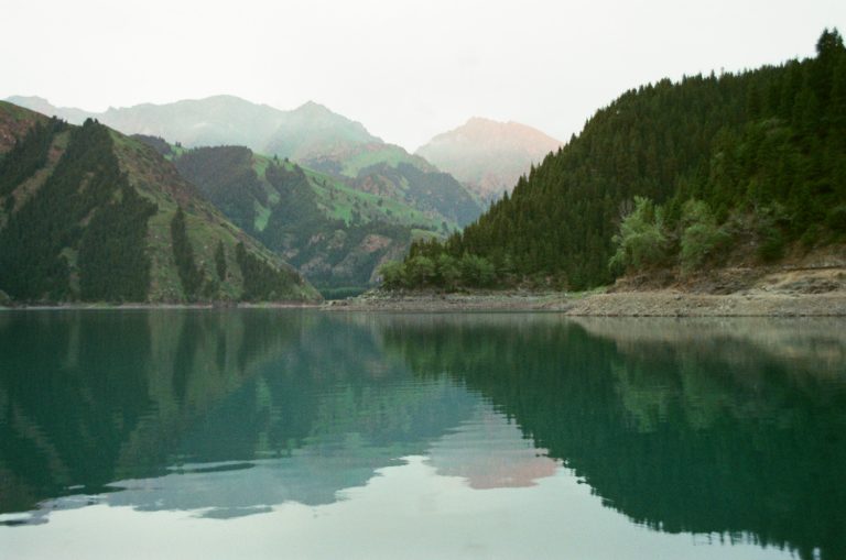 A mountain lake reflecting a forested valley